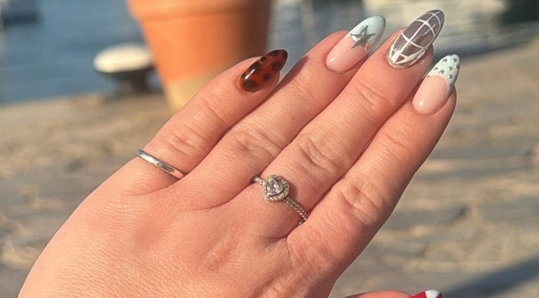 Artistic nail design from Nails by Lauren M in Morpeth, England, GB, showcasing intricate patterns under sunlight.