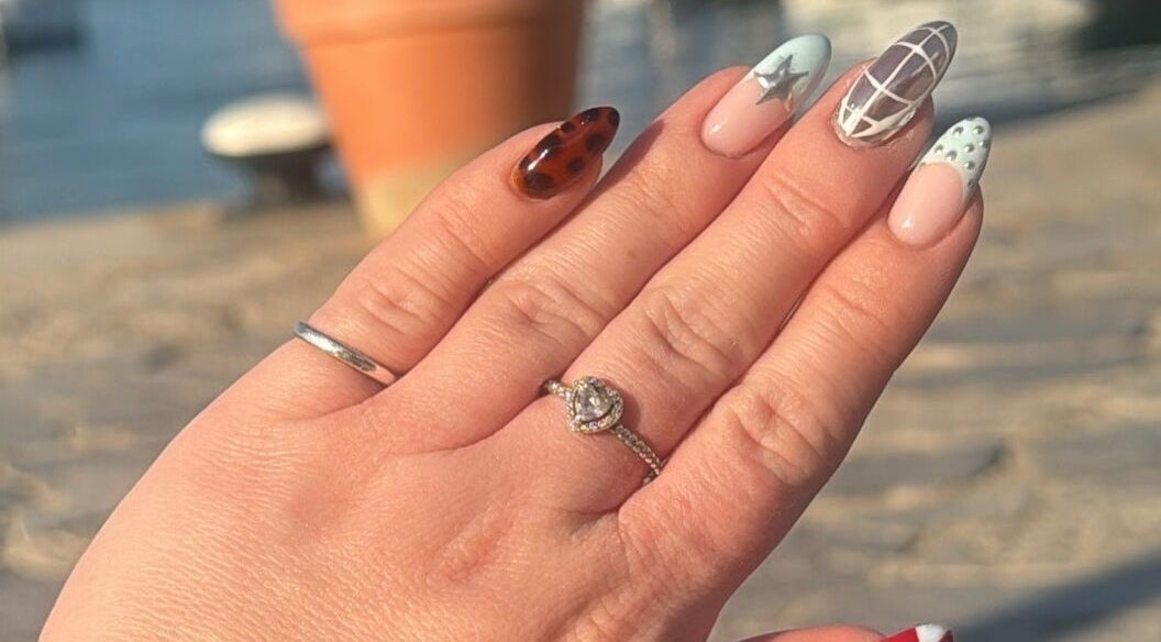 Artistic nail design from Nails by Lauren M in Morpeth, England, GB, showcasing intricate patterns under sunlight.