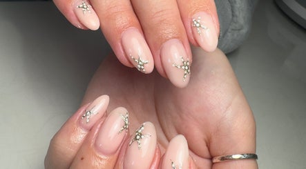 Close-up of embellished nude nails at Nails by Lauren M, Morpeth, England, GB.