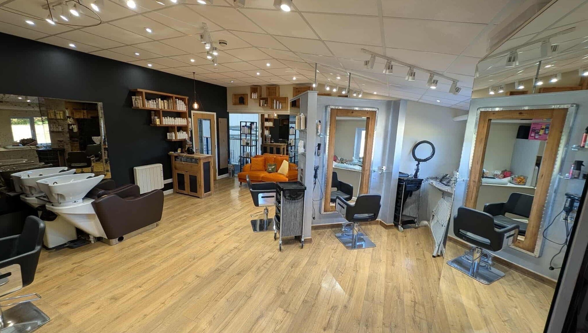 Modern beauty salon at Essence, Bourton-on-the-Water, England, GB with stylish decor and comfortable seating.
