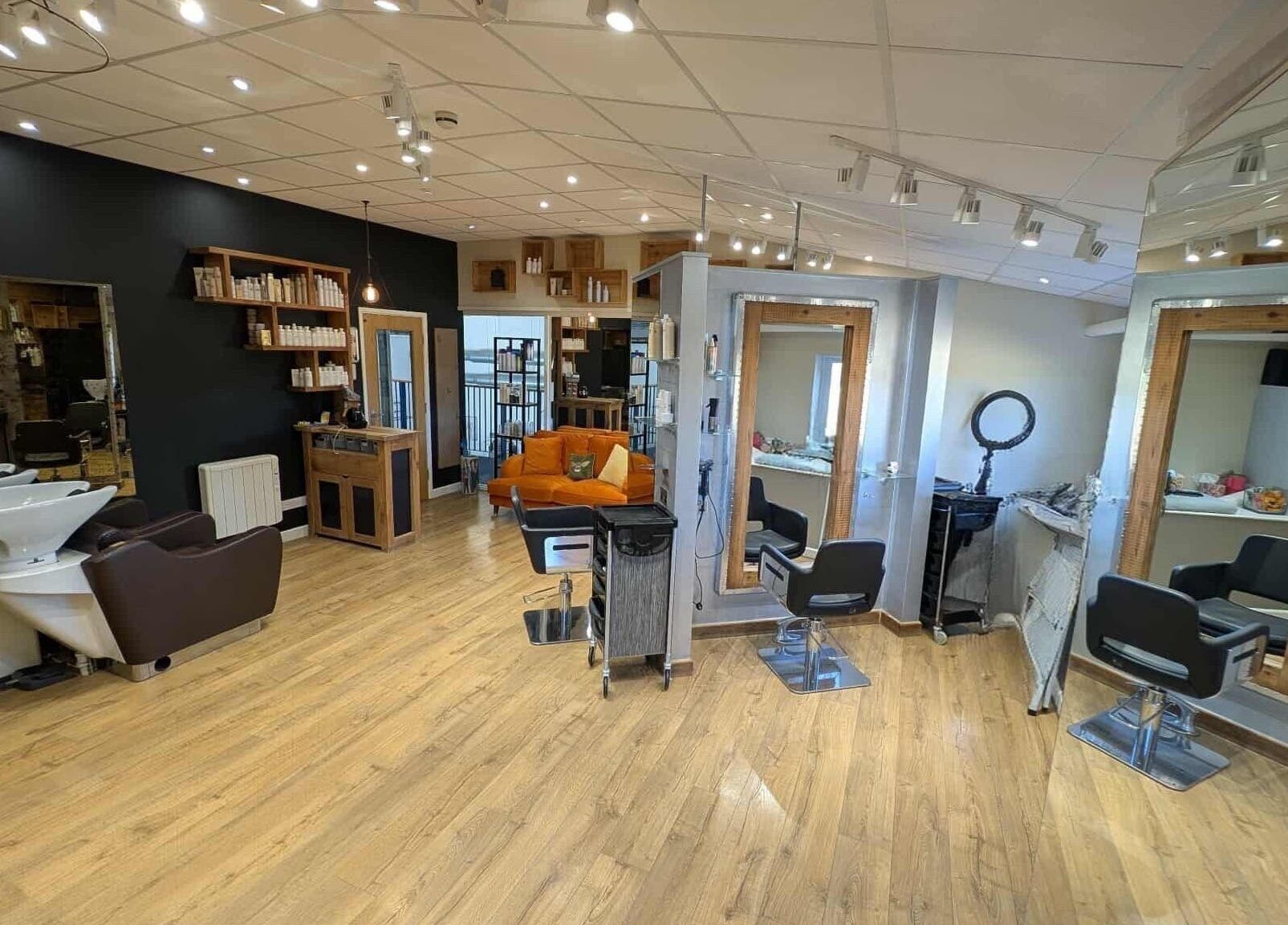 Modern beauty salon at Essence, Bourton-on-the-Water, England, GB with stylish decor and comfortable seating.