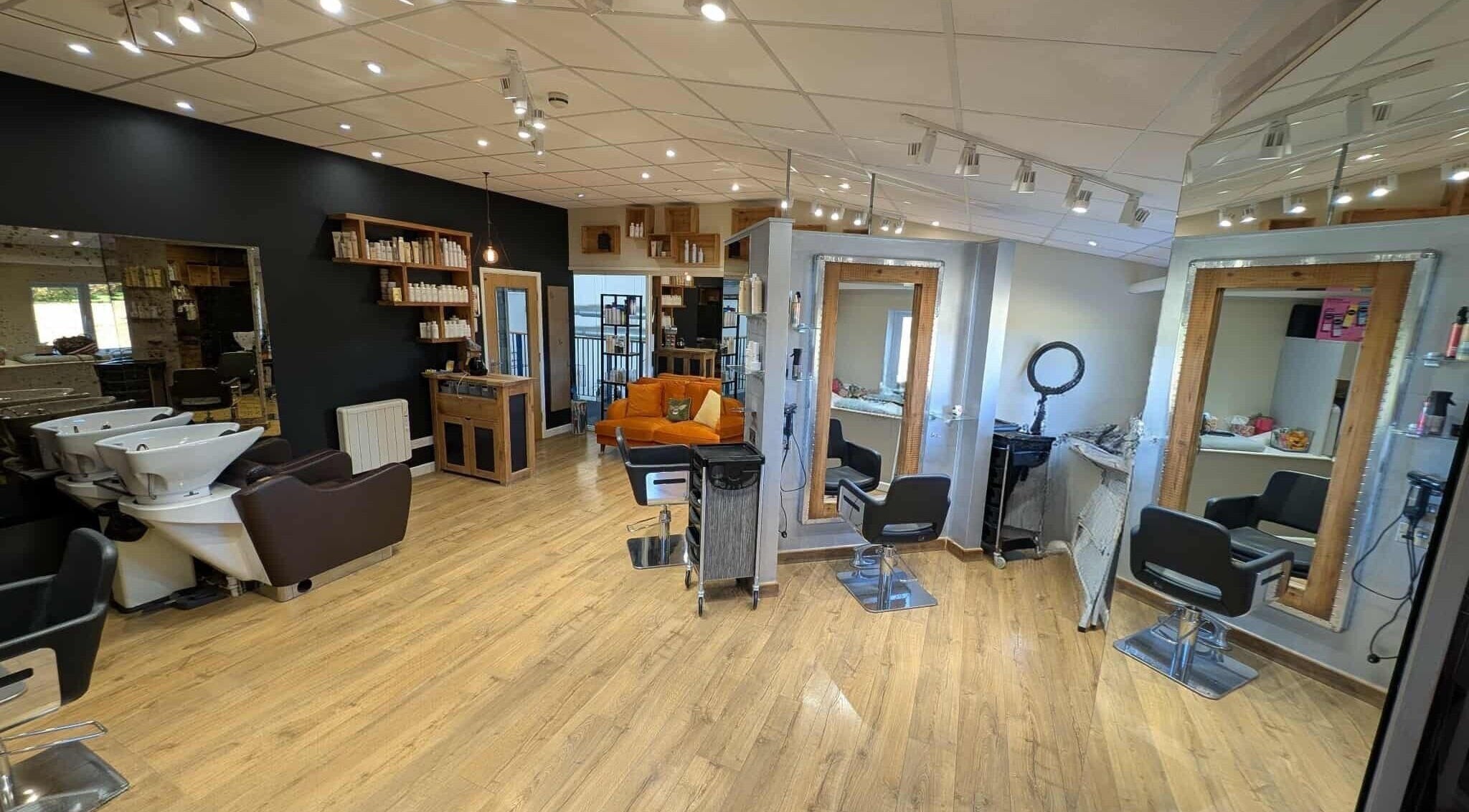 Modern beauty salon at Essence, Bourton-on-the-Water, England, GB with stylish decor and comfortable seating.