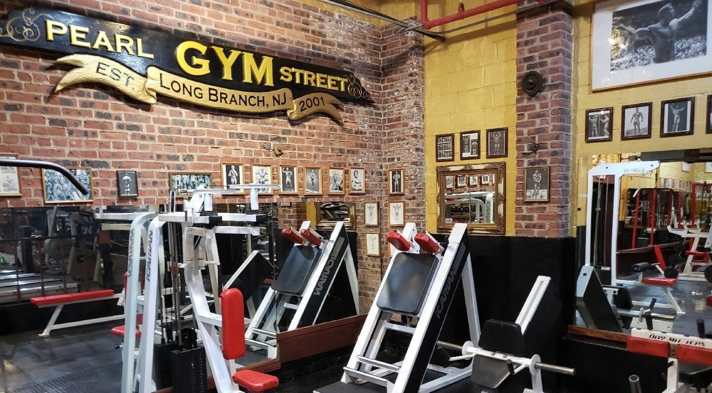 Authentic gym interior at Building You in Long Branch, New Jersey, US, featuring brick walls and workout equipment.