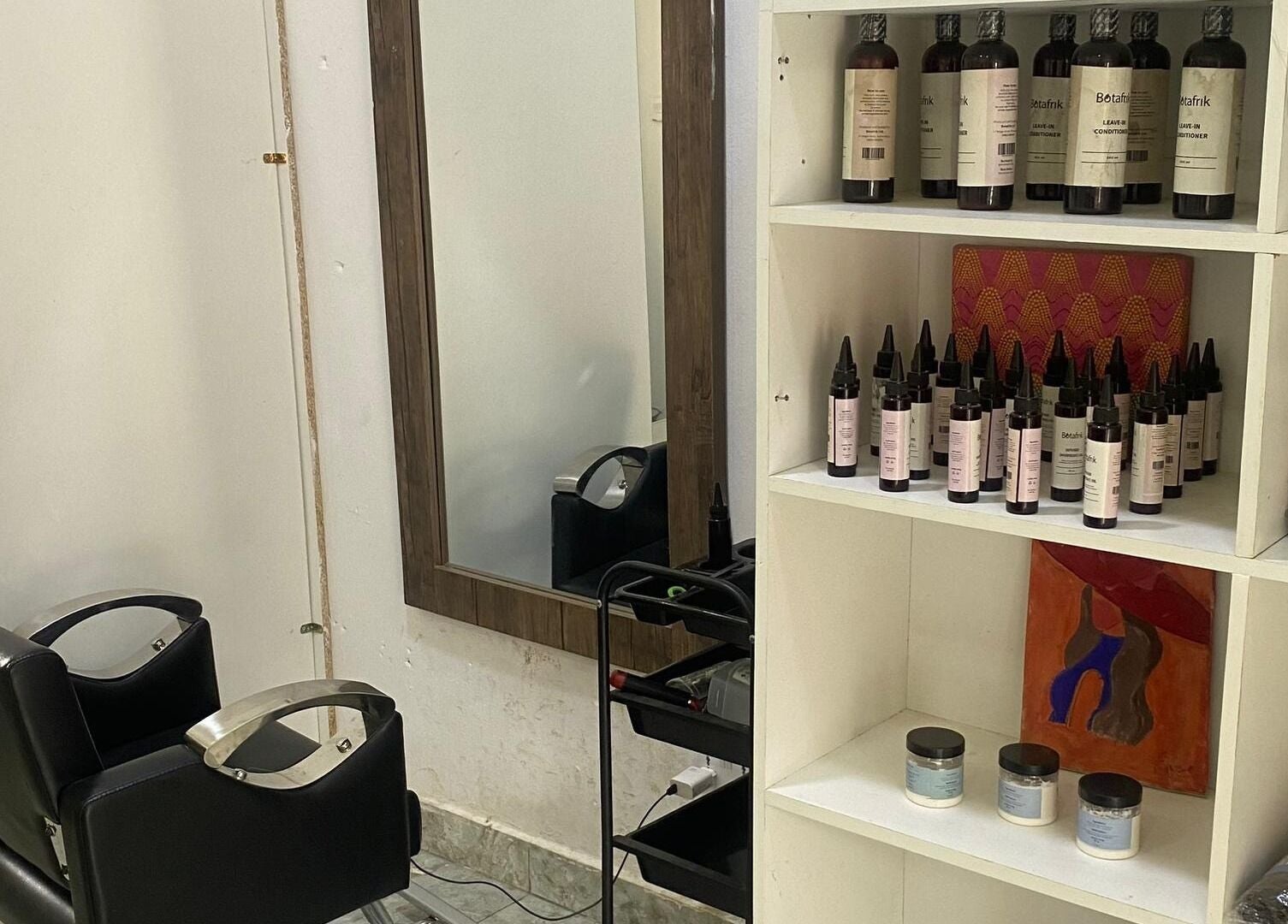 Modern salon station at Hairloom Salon, Lugbe, Iddo Tudunwada, Federal Capital Territory, NG with products on display.