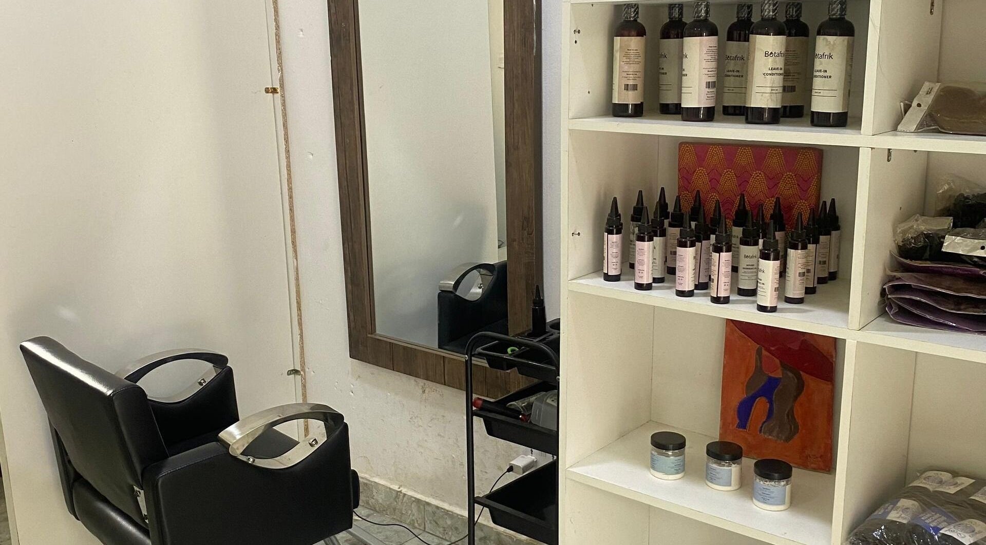 Modern salon station at Hairloom Salon, Lugbe, Iddo Tudunwada, Federal Capital Territory, NG with products on display.