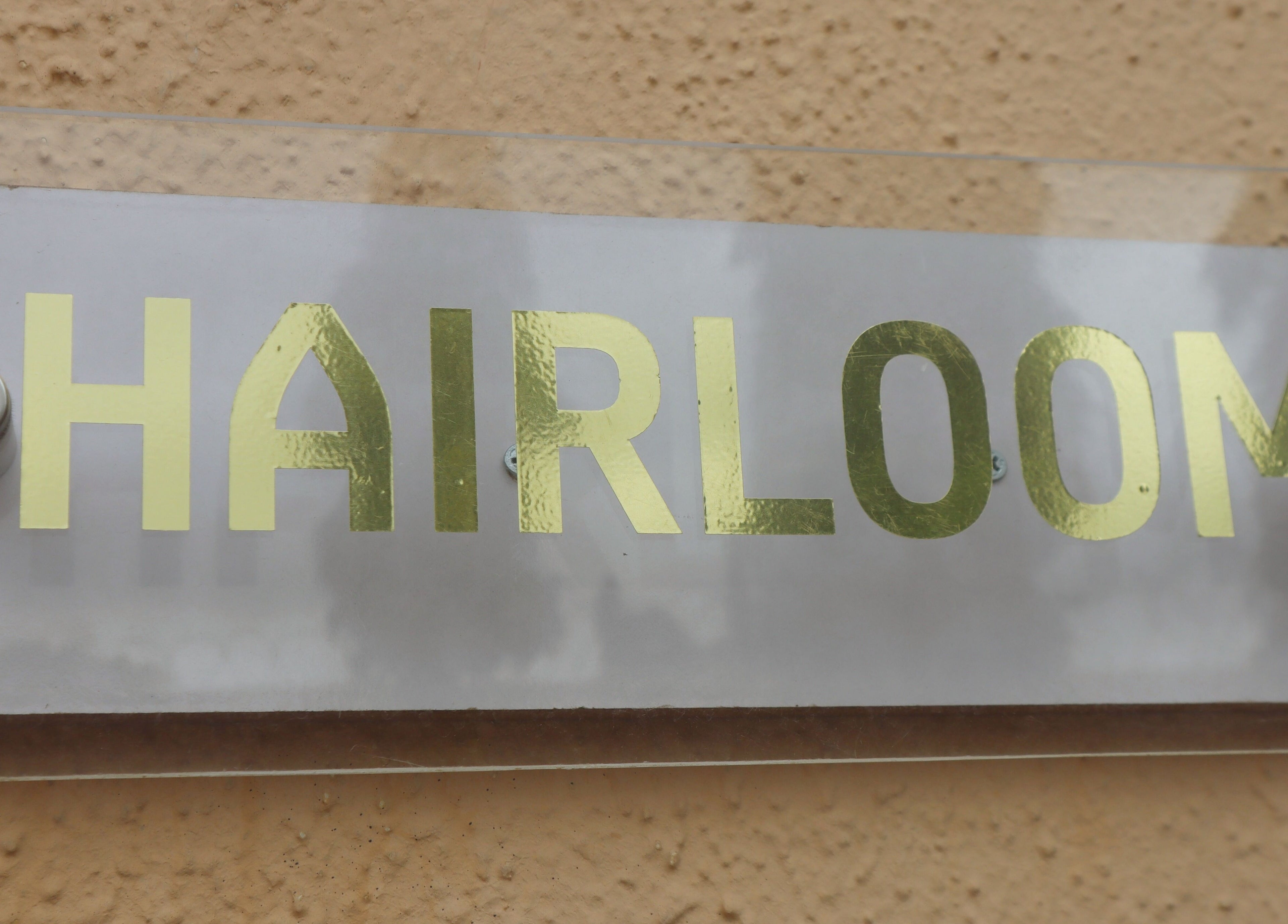 Hairloom Salon, Lugbe sign at Iddo Tudunwada, Federal Capital Territory, NG, features bold gold lettering.