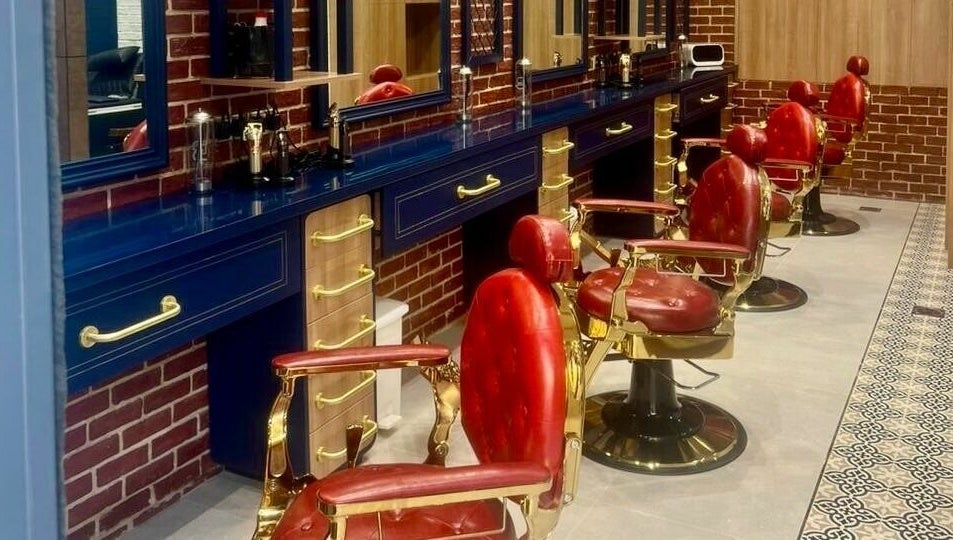 Sophisticated interior of Doc Barnet - Aljada Solo, featuring vintage red barber chairs in Sharjah, Sharjah, AE.