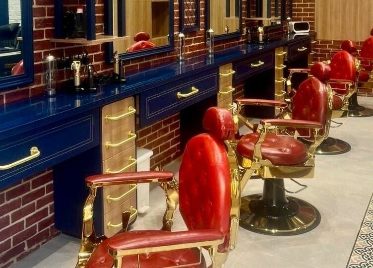 Sophisticated interior of Doc Barnet - Aljada Solo, featuring vintage red barber chairs in Sharjah, Sharjah, AE.