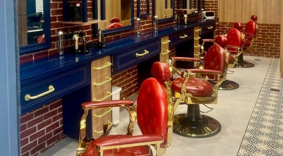 Sophisticated interior of Doc Barnet - Aljada Solo, featuring vintage red barber chairs in Sharjah, Sharjah, AE.