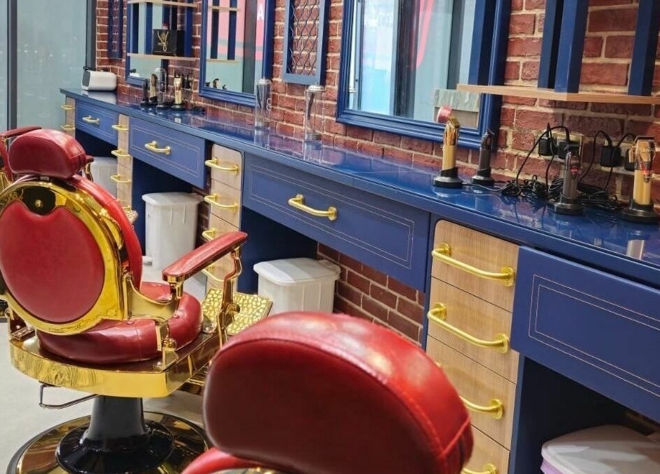 Elegant barber chairs and blue counter at Doc Barnet - Aljada Solo, Sharjah, Sharjah, AE.