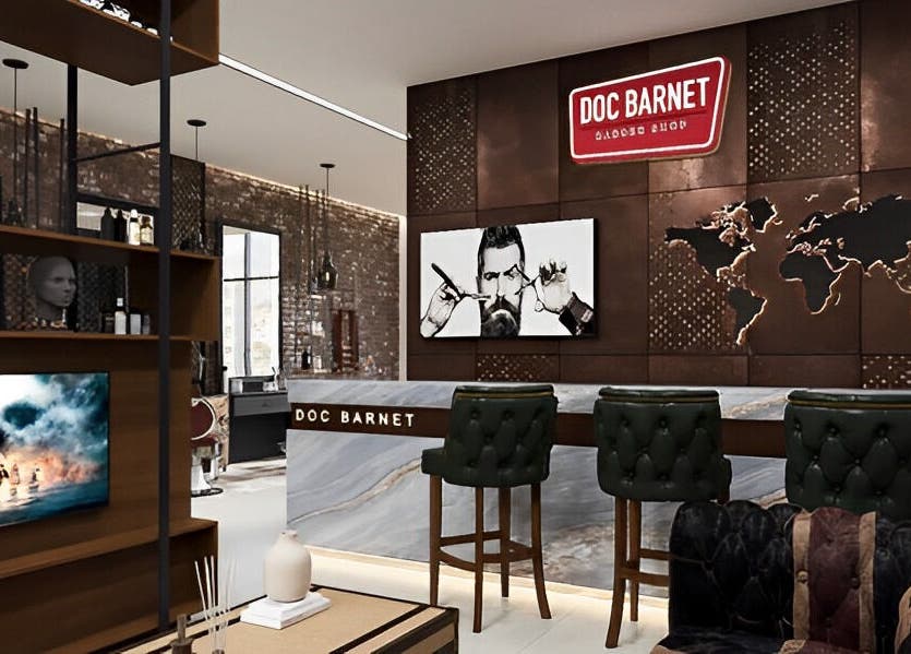 Interior of Doc Barnet - Nasma Resident in Sharjah, AE showcasing stylish salon design with leather chairs.