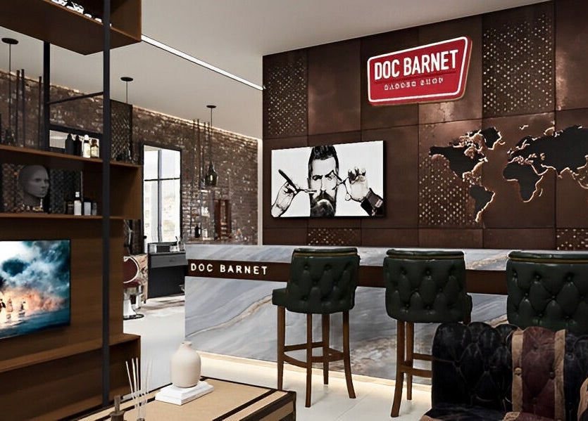 Interior of Doc Barnet - Nasma Resident in Sharjah, AE showcasing stylish salon design with leather chairs.