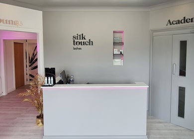 Reception area of Silk Touch Lashes Glenrothes, Scotland with modern decor and warm lighting.