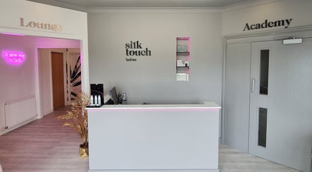 Reception area of Silk Touch Lashes Glenrothes, Scotland with modern decor and warm lighting.