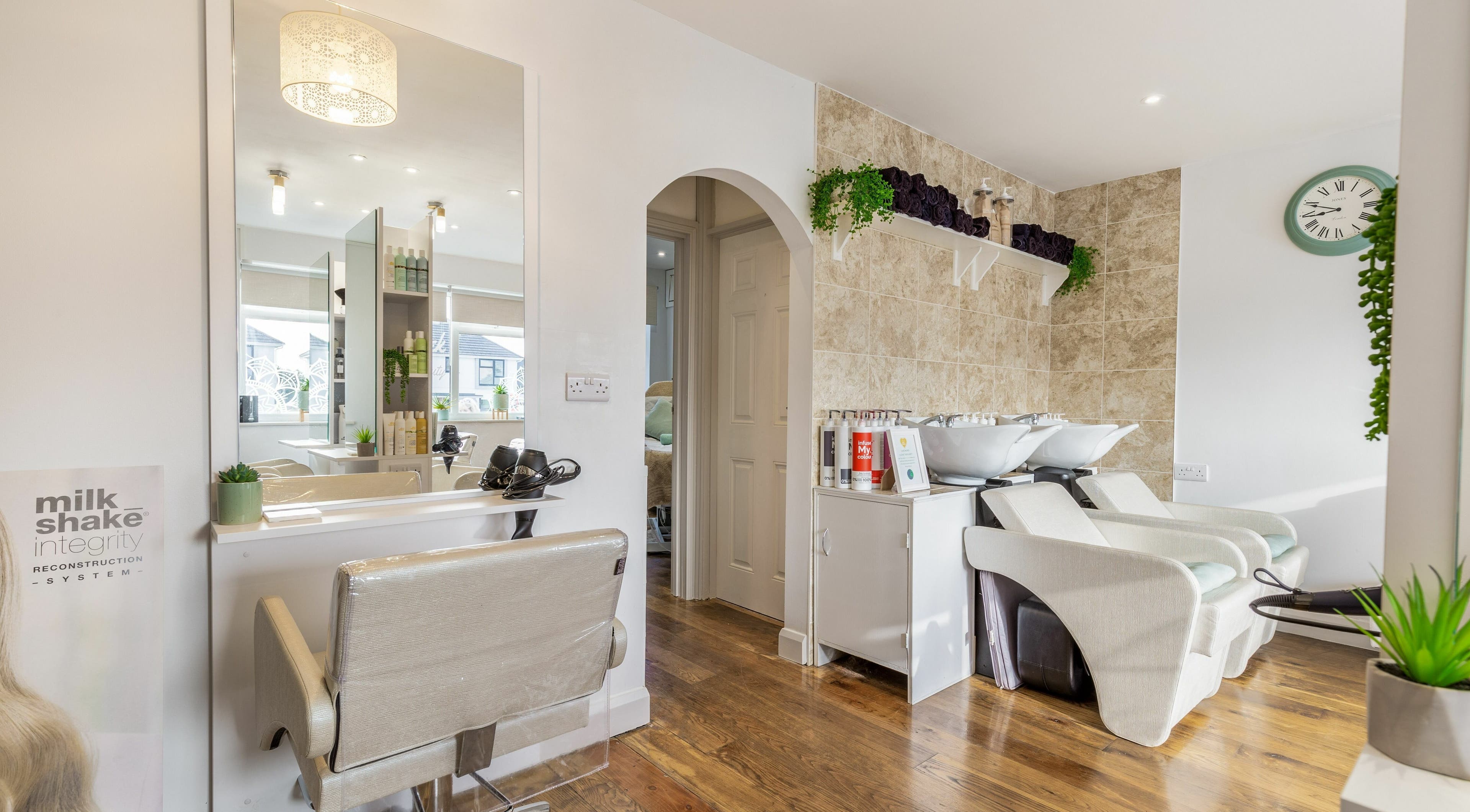 Modern salon interior at Lowenek Hair and Beauty Ltd., Threemilestone, England, GB, with sleek styling stations.