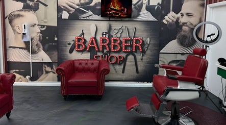 Interior of The Head Office Barber Shop in Nassau, BS, featuring red chairs and vintage decor.