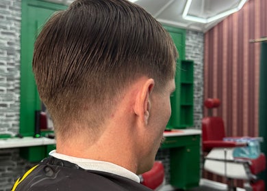 Man with stylish haircut at The Head Office Barber Shop, Nassau, BS, showcasing expert grooming.
