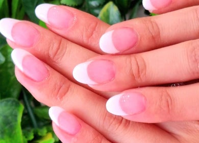 Elegant French manicure from Nails by Christina, Bridgwater, England, GB on natural hands with soft pink polish.
