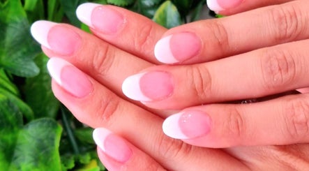 Elegant French manicure from Nails by Christina, Bridgwater, England, GB on natural hands with soft pink polish.