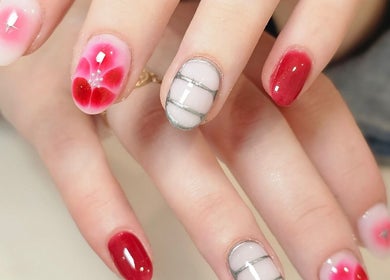 Elegant nail art at Nails by Christina in Bridgwater, England, GB. Featuring red and white designs.