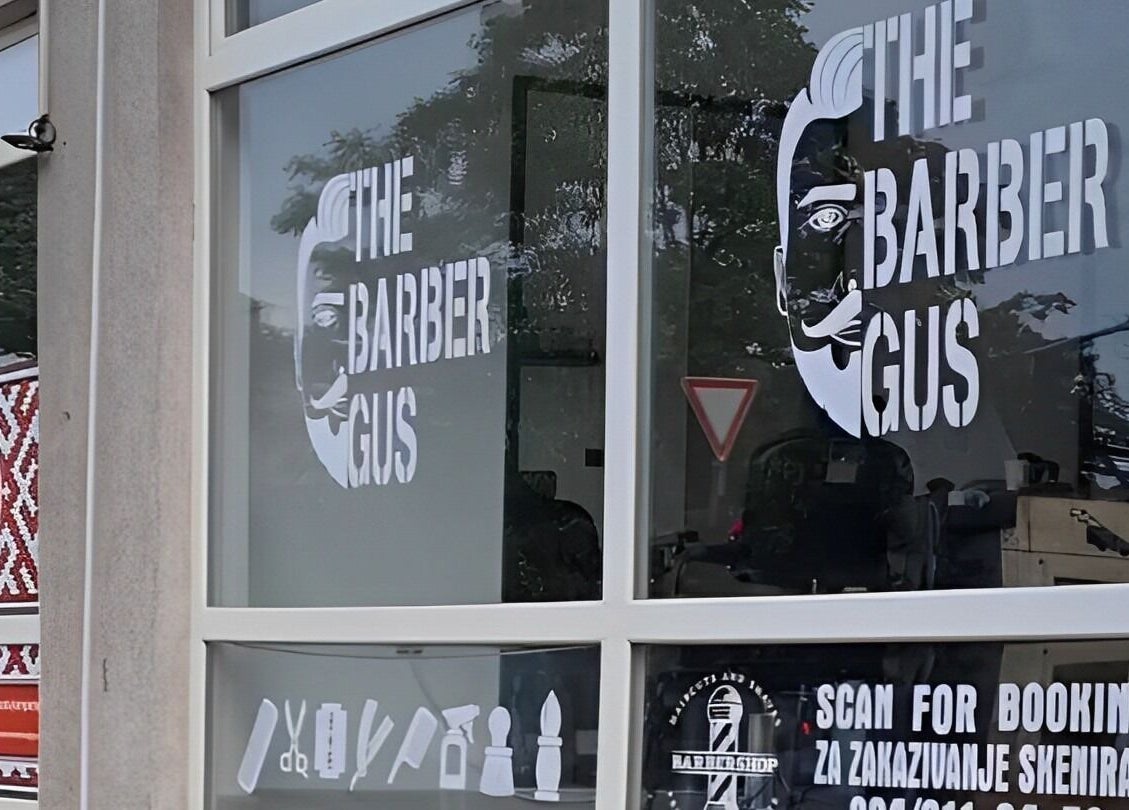 Front view of The Barber Gus in Novi Sad, Vojvodina, RS, showcasing the distinctive logo on the window.