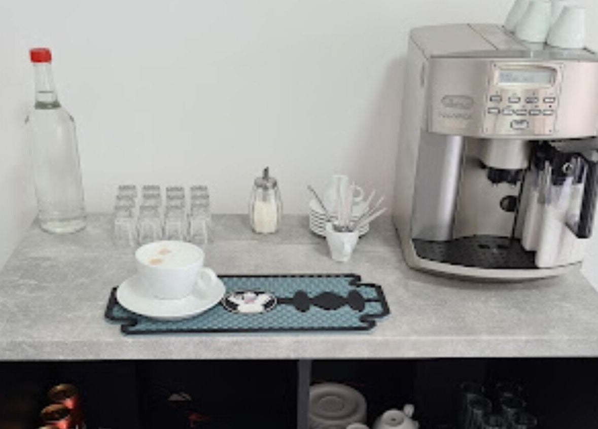 Coffee machine and cup at The Barber Gus, Novi Sad, Vojvodina, RS, creating a warm and inviting atmosphere.