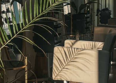 Chic MORUHAIR salon interior in Tallinn, Harju maakond, EE with modern chairs and plants.