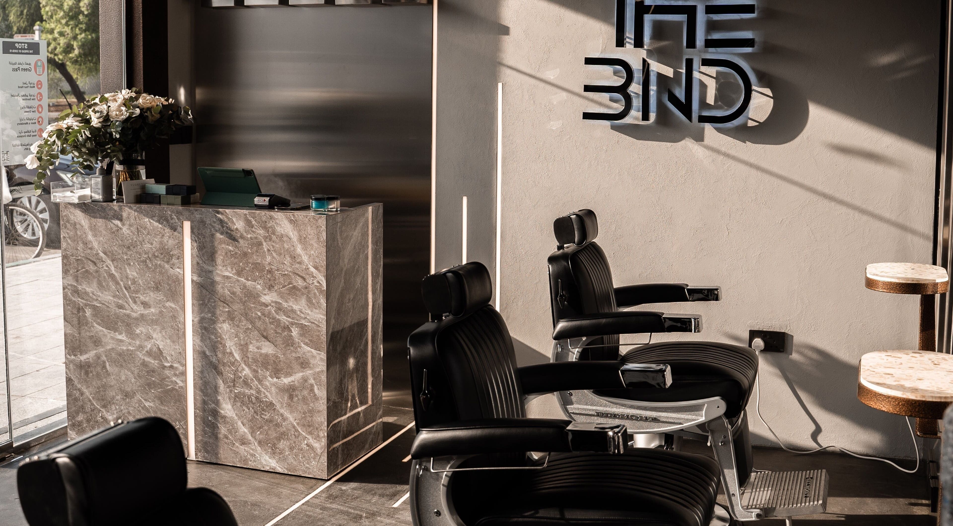 Elegant interior of The BND - Barber Next Door in Abu Dhabi, AE, featuring stylish barber chairs and modern decor.