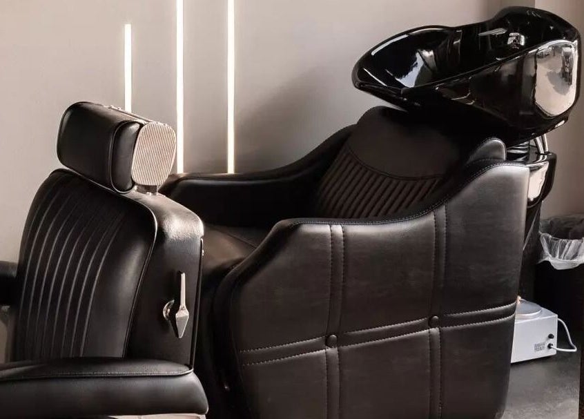 Luxurious salon chair at The BND - Barber Next Door, Abu Dhabi, AE showcases comfort and style.