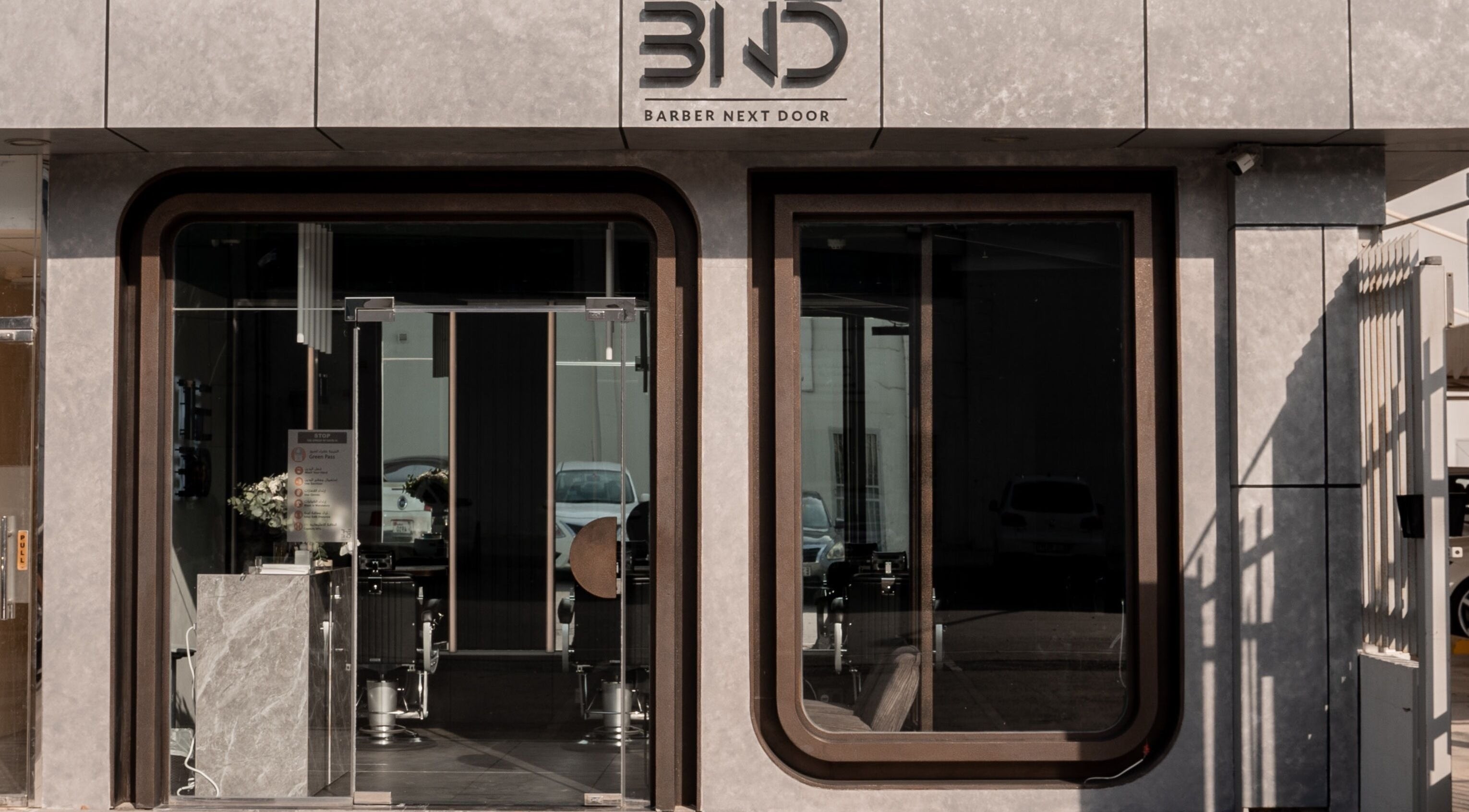 Front entrance of The BND - Barber Next Door in Abu Dhabi, AE showcasing modern design.