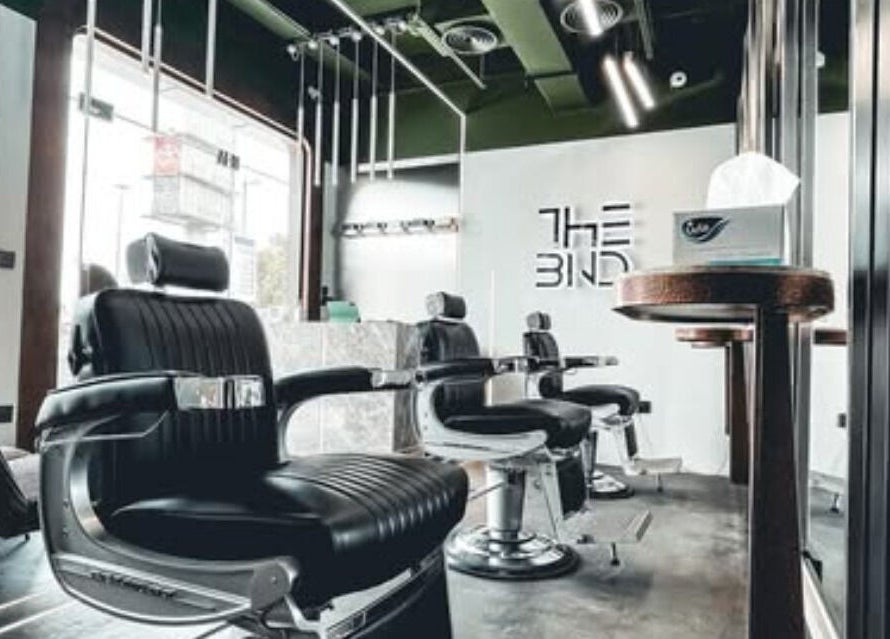 Modern barber chairs at The BND - Barber Next Door in Abu Dhabi, AE, showcasing luxury and comfort.