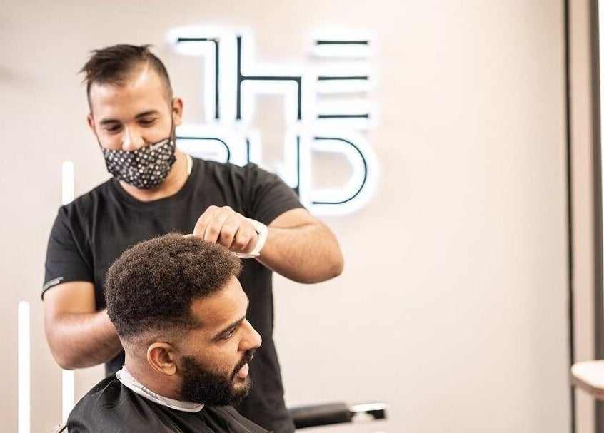 Barber giving a haircut at The BND - Barber Next Door in Abu Dhabi, AE.