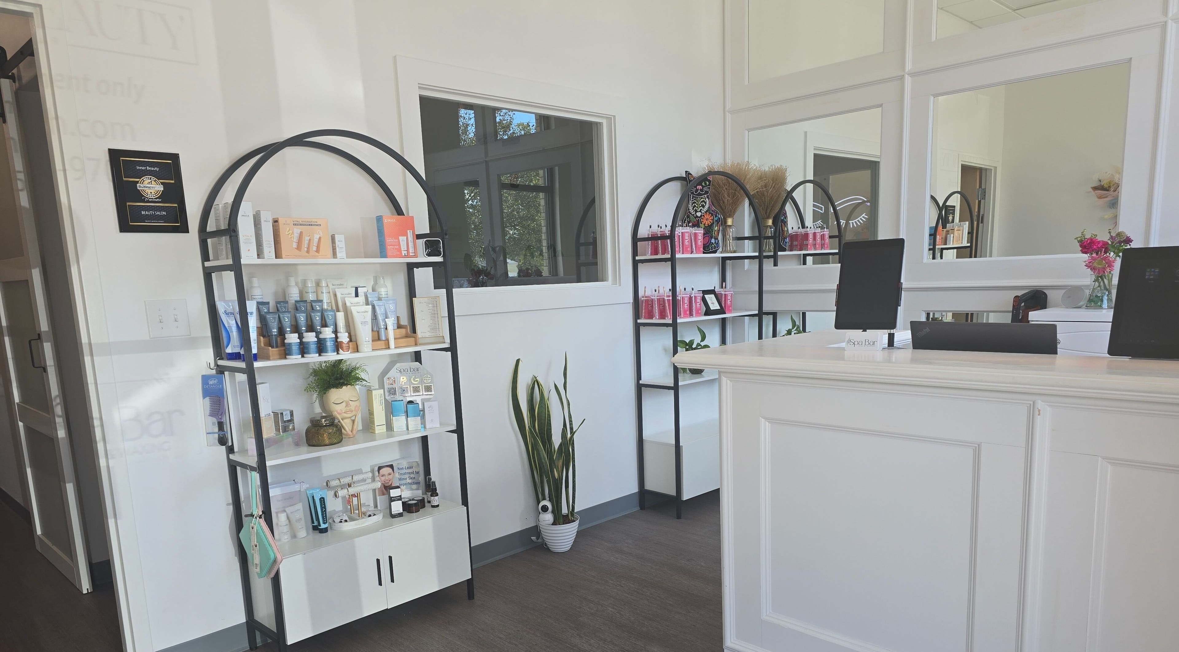 Elegant reception area at The Spa Bar in Manchester, New Hampshire, US showcasing beauty products and modern decor.