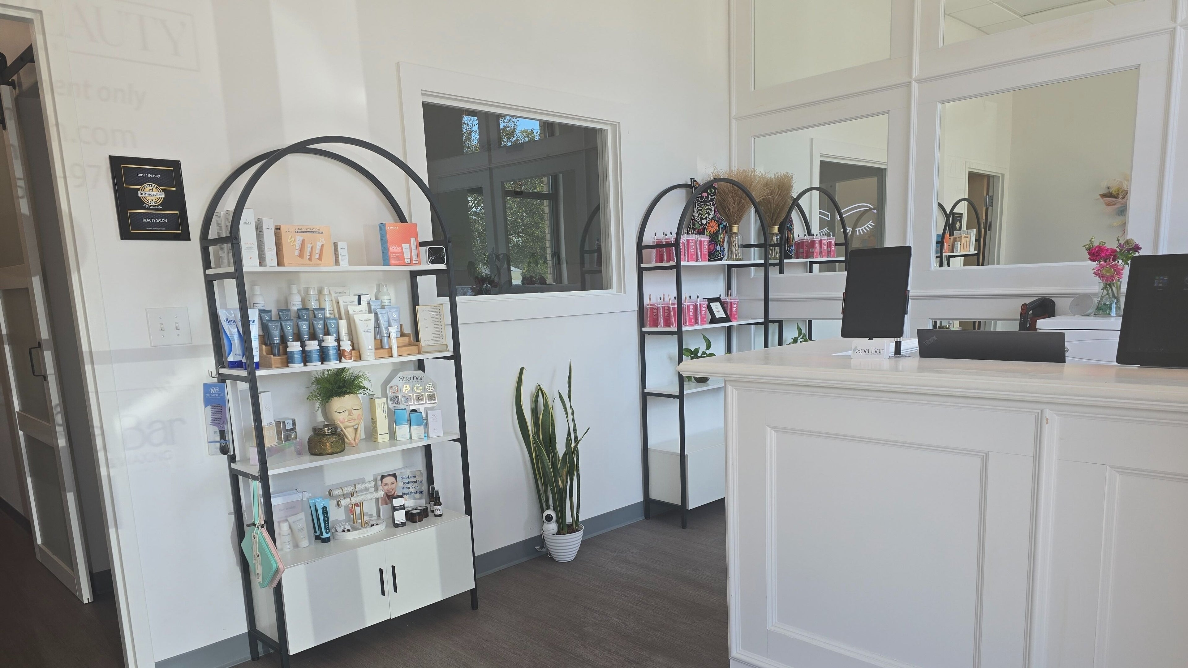 Elegant reception area at The Spa Bar in Manchester, New Hampshire, US showcasing beauty products and modern decor.