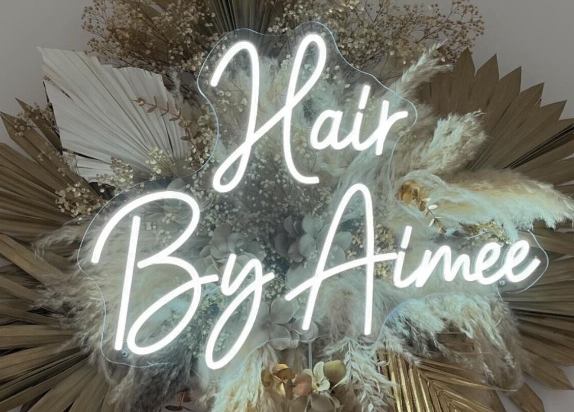 Illuminated Hair by Aimee sign with floral decor at Hatfield, England, GB.