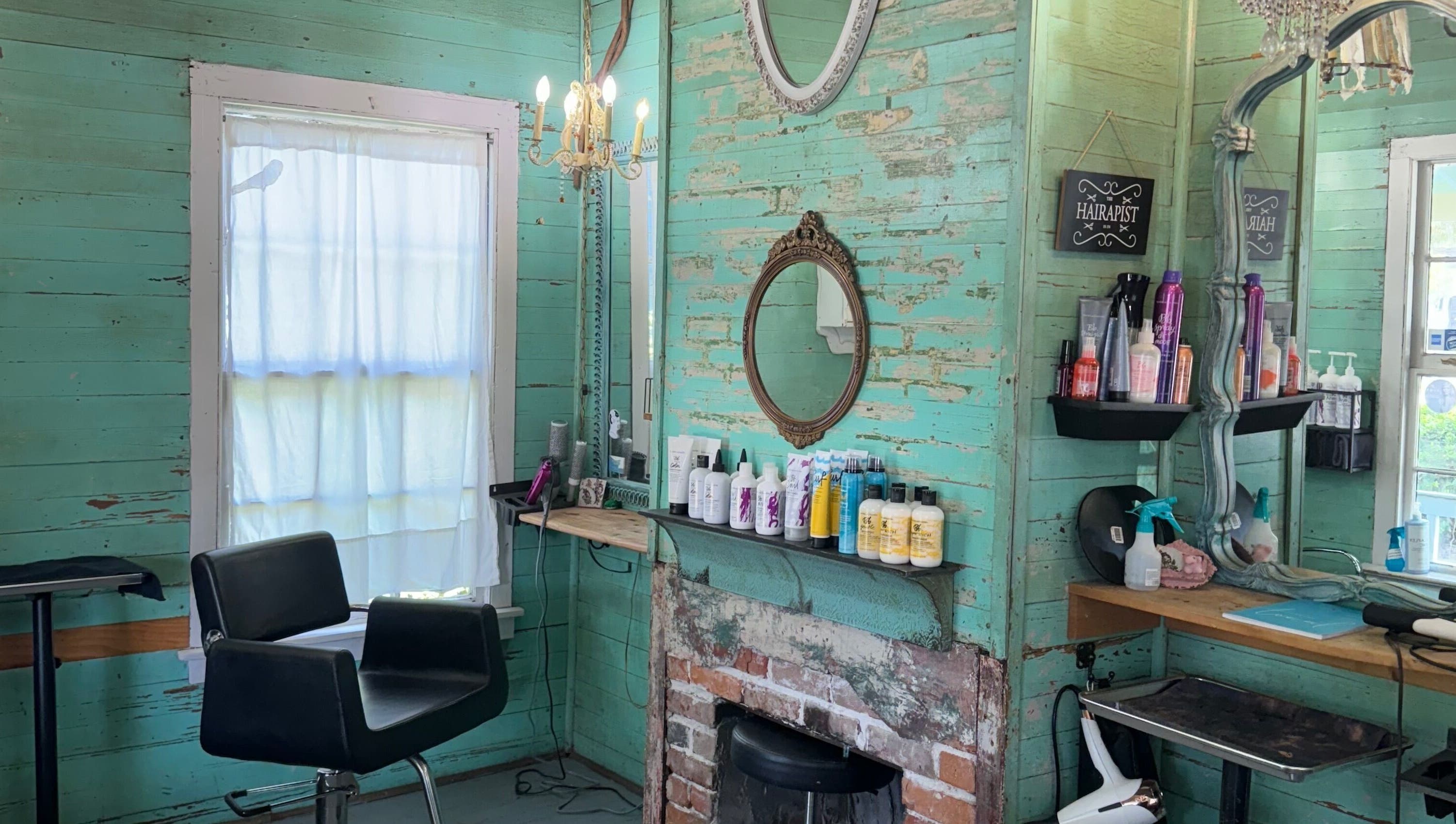 Charming vintage interior of The Bearded Lady Salon in Fernandina Beach, Florida, featuring rustic decor and styling chair.