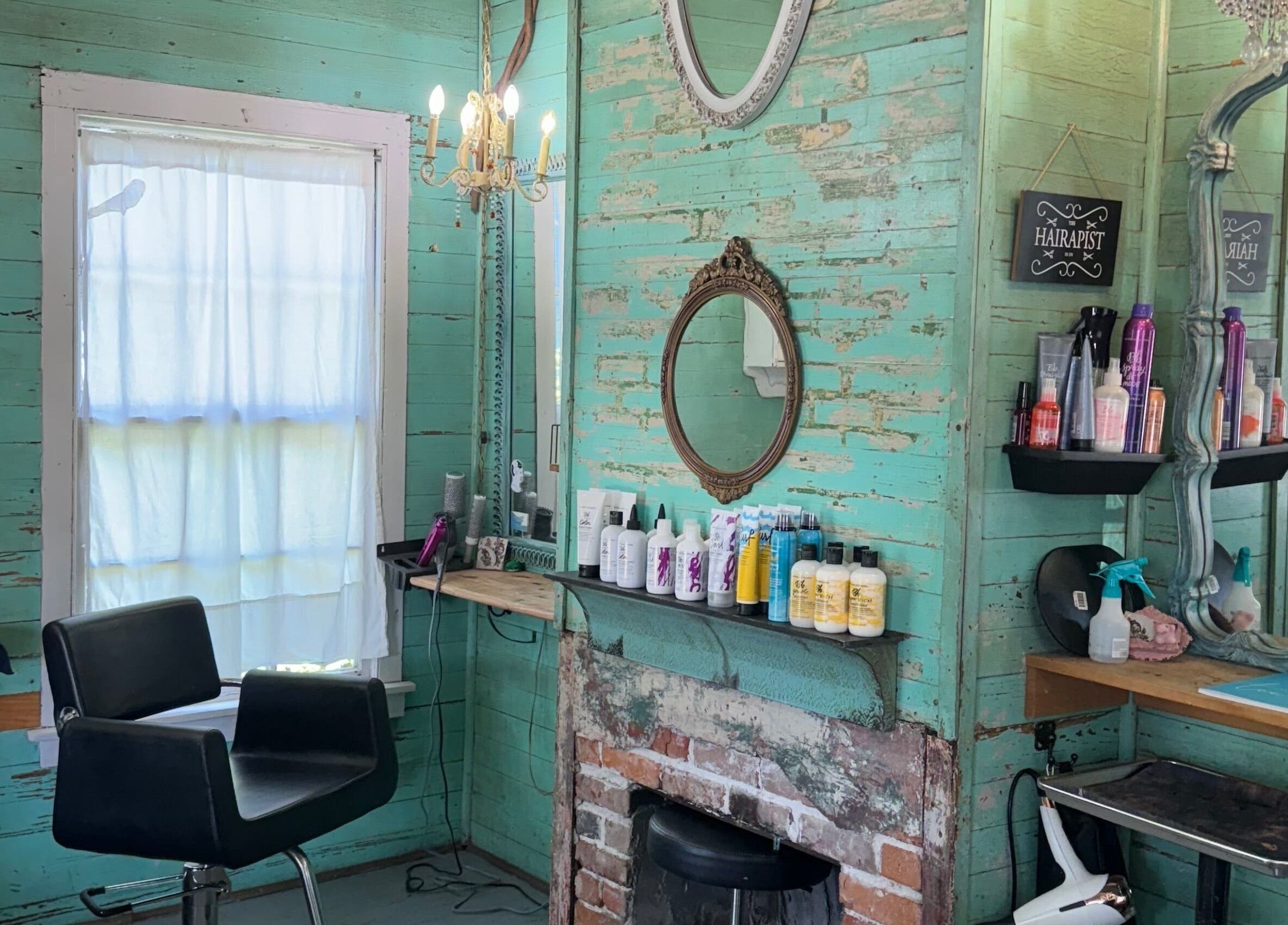 Charming vintage interior of The Bearded Lady Salon in Fernandina Beach, Florida, featuring rustic decor and styling chair.