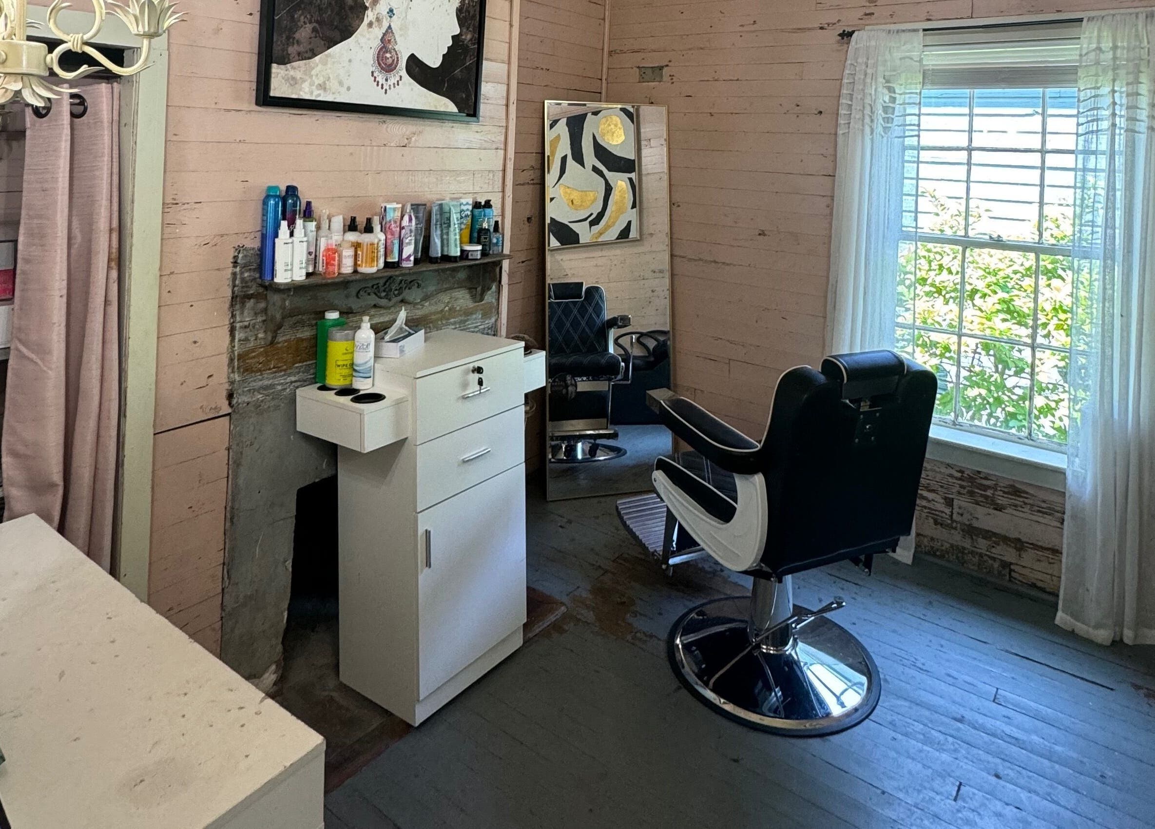 Chic styling area at The Bearded Lady Salon, Fernandina Beach, Florida, US with rustic charm and modern chairs.