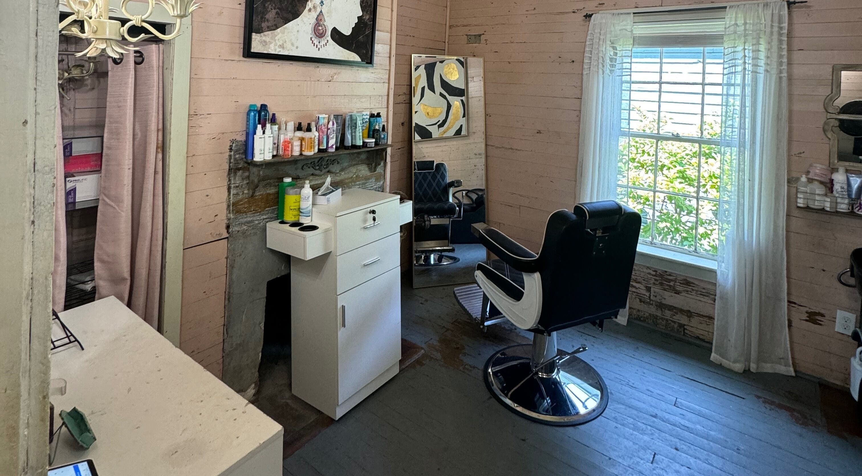 Chic styling area at The Bearded Lady Salon, Fernandina Beach, Florida, US with rustic charm and modern chairs.