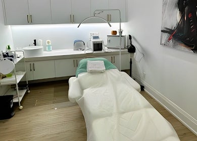 Cozy treatment room at Skin Cave Beauty in Mississauga, Ontario, CA, featuring a plush massage table.