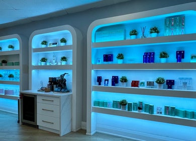 Illuminated shelves with beauty products at Skin Cave Beauty in Mississauga, Ontario, CA.