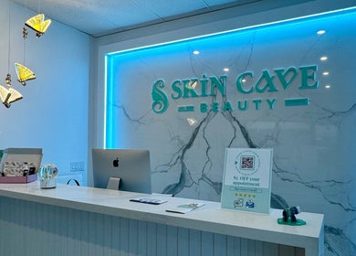 Reception area at Skin Cave Beauty in Mississauga, Ontario, CA with modern desk and soothing lights.