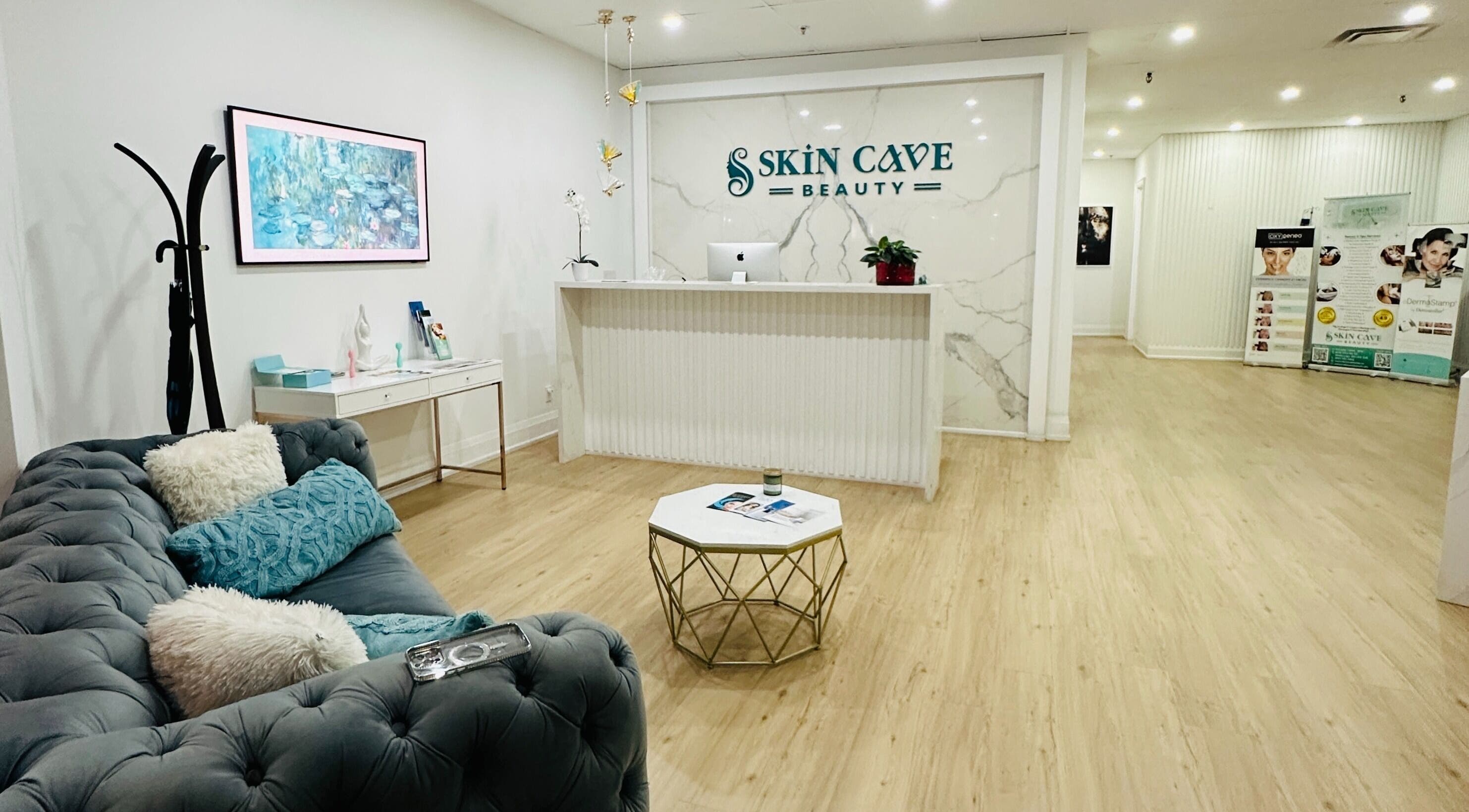 Elegant reception area at Skin Cave Beauty in Mississauga, Ontario, CA with plush seating and modern decor.