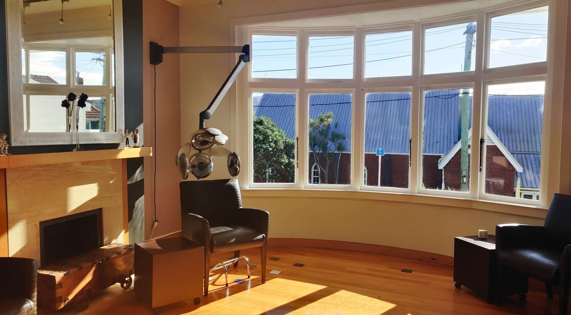 Bright, comfortable seating in David's Hairstylists, Wellington, NZ, with large windows and modern decor.
