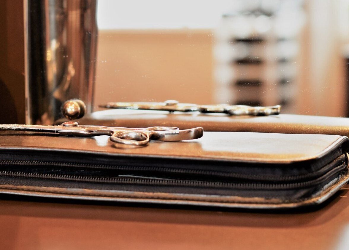 Professional scissors on a leather wallet at David's Hairstylists, Wellington, Wellington, NZ.