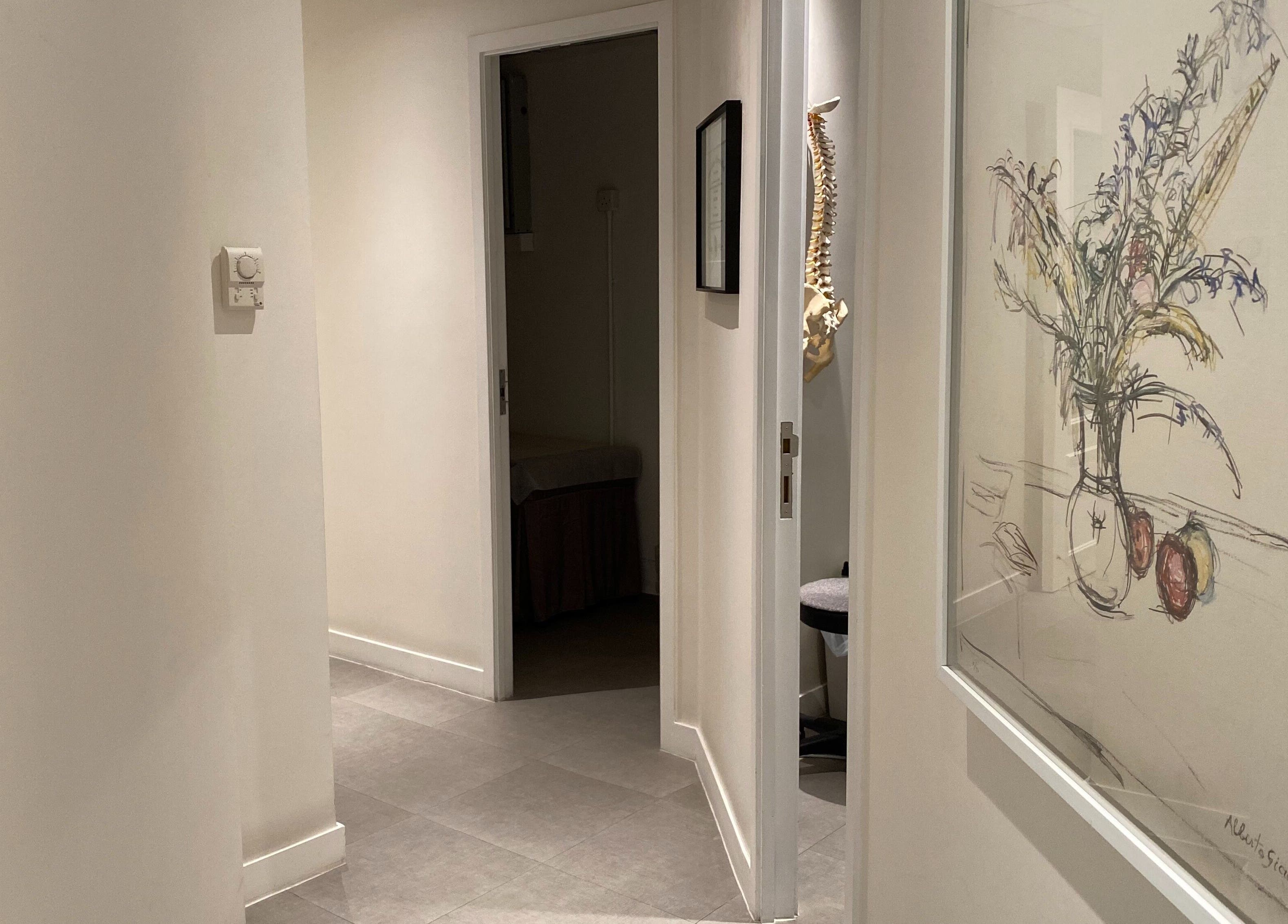 Hallway at Rin Aesthetics - Korean Facials and Laser Treatment on Hong Kong Island, featuring modern decor and art.
