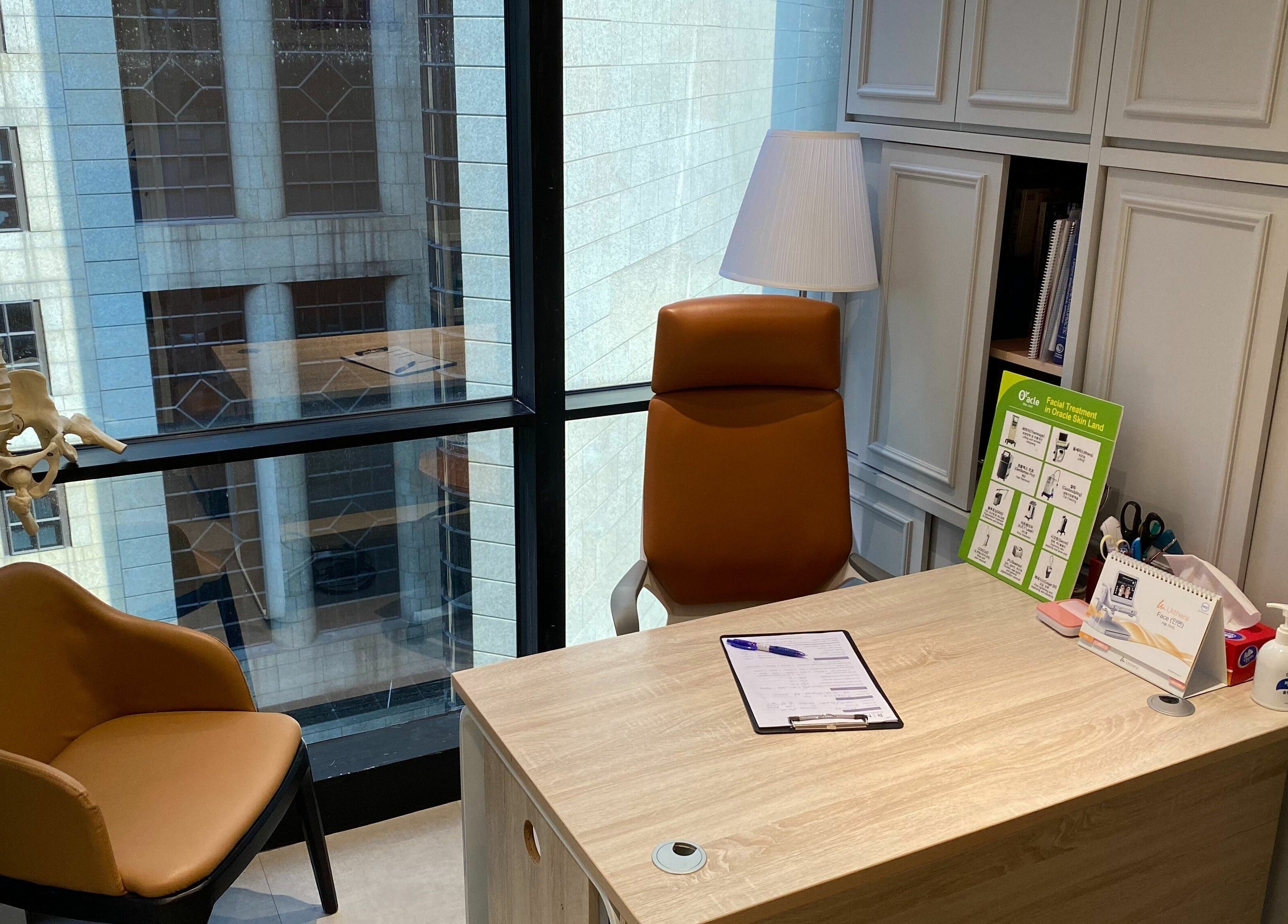Consultation room at Rin Spine Clinic on Hong Kong Island, HK, featuring comfortable seating and a desk.