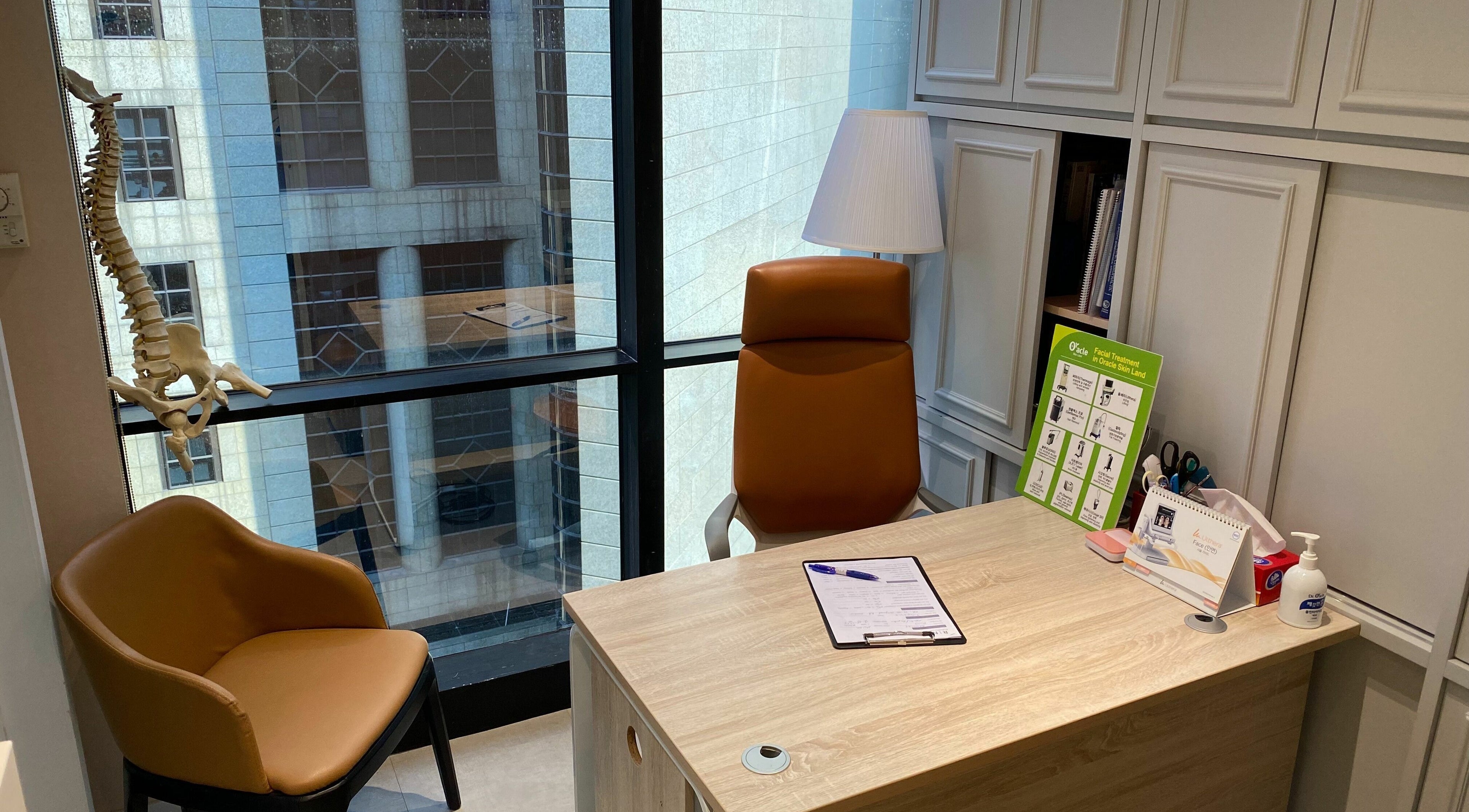 Consultation room at Rin Spine Clinic on Hong Kong Island, HK, featuring comfortable seating and a desk.