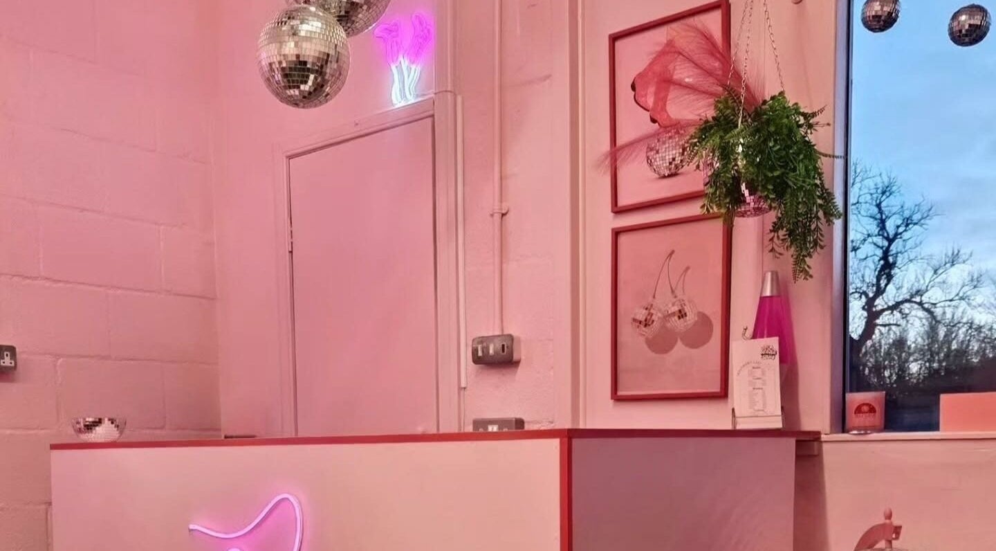 Stylish interior of BadaBing Beauty in Glenrothes, Scotland, GB with pink decor and disco balls.