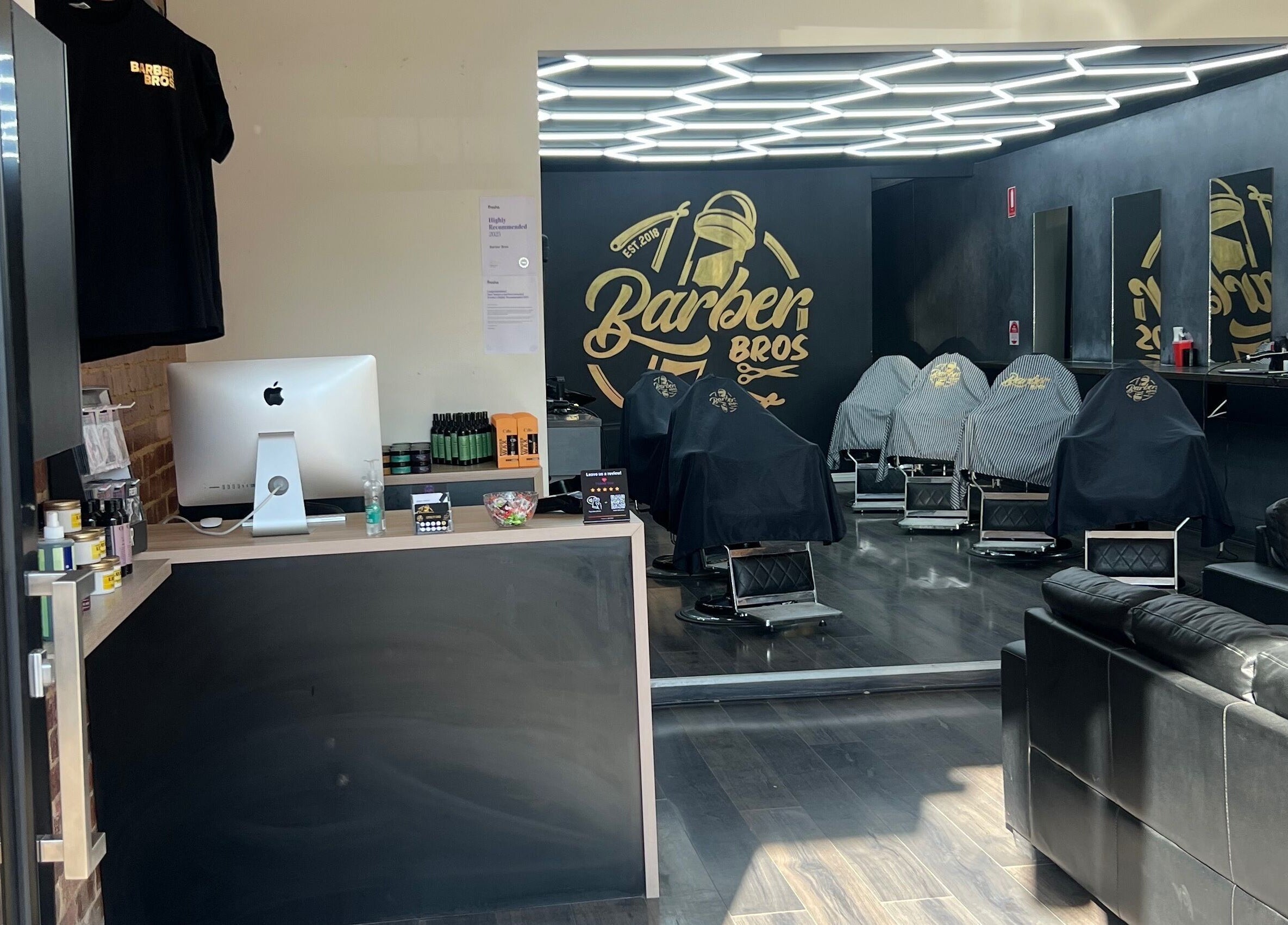 Modern interior of Barber Bros in Melbourne, Victoria, AU featuring stylish chairs and sleek decor.